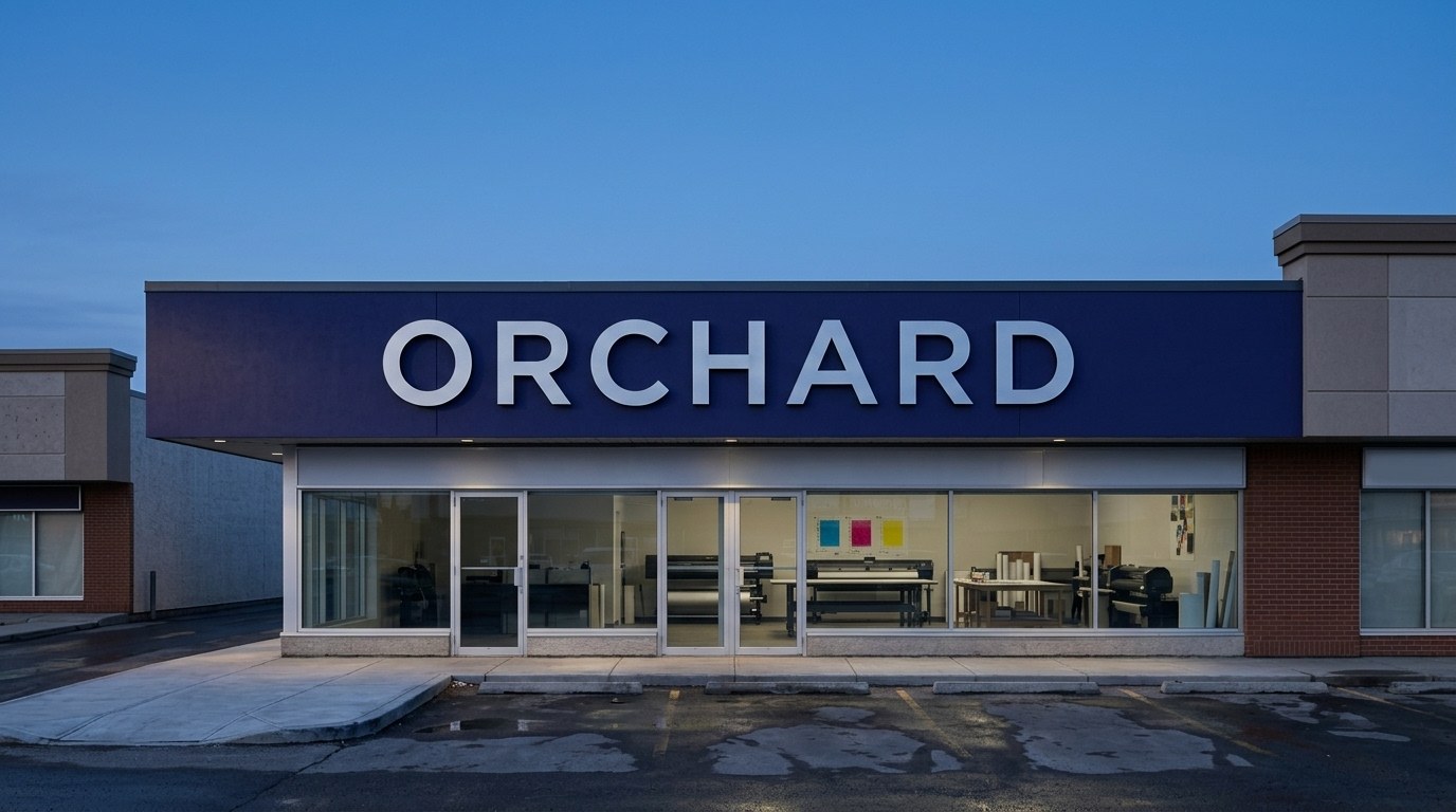 A storefront at dusk with its sign about to light up.
